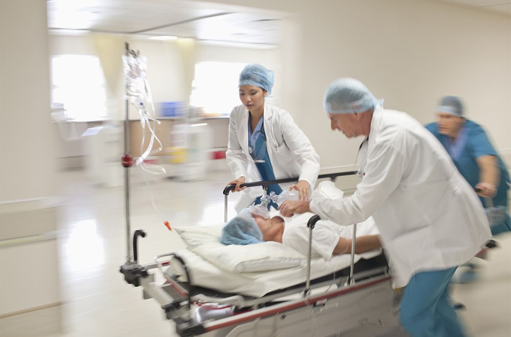 Doctors rush patient to ER with oxygen mask on